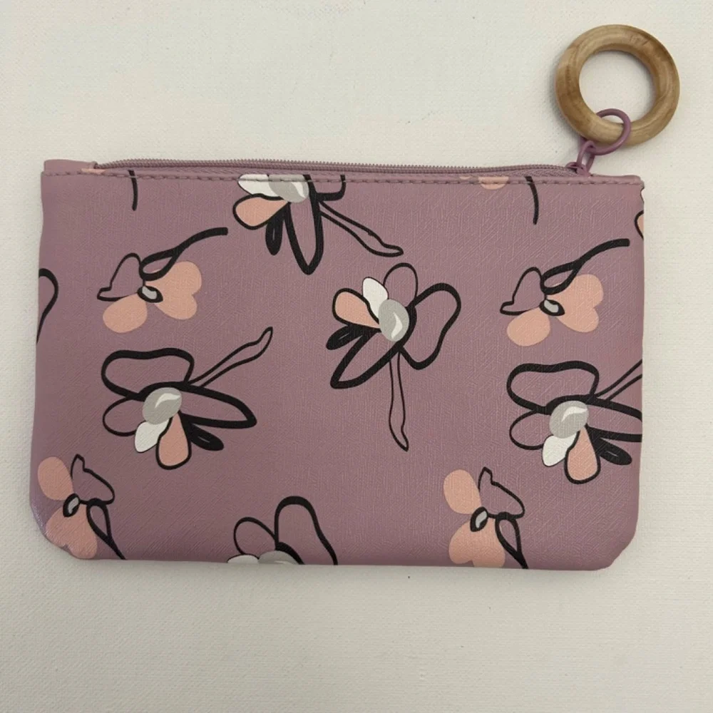 Ipsy Glam Bag featuring a lavender floral print & signature wooden zipper pull